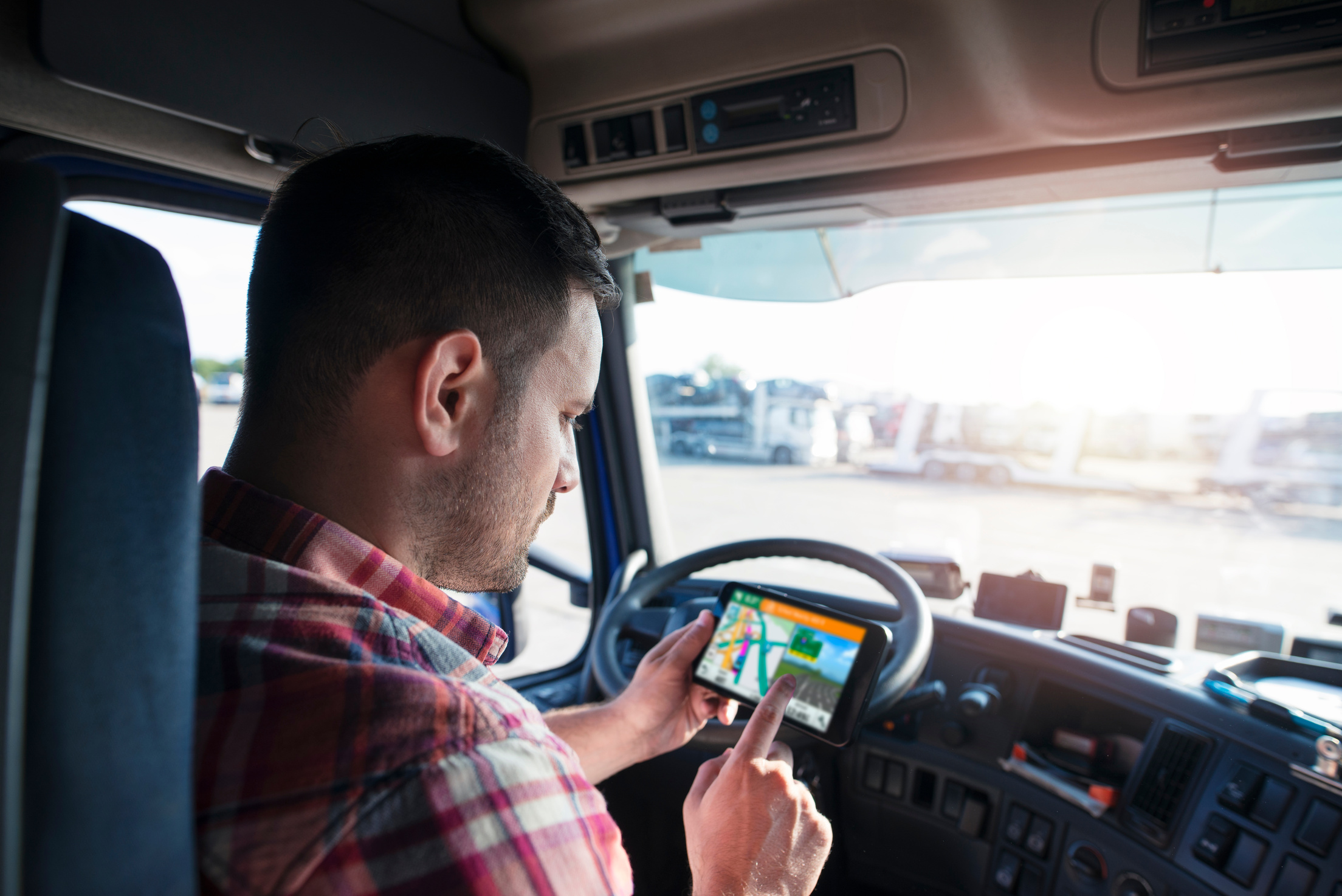 Truck driver using GPS to deliver goods. Transportation services with global positioning system.